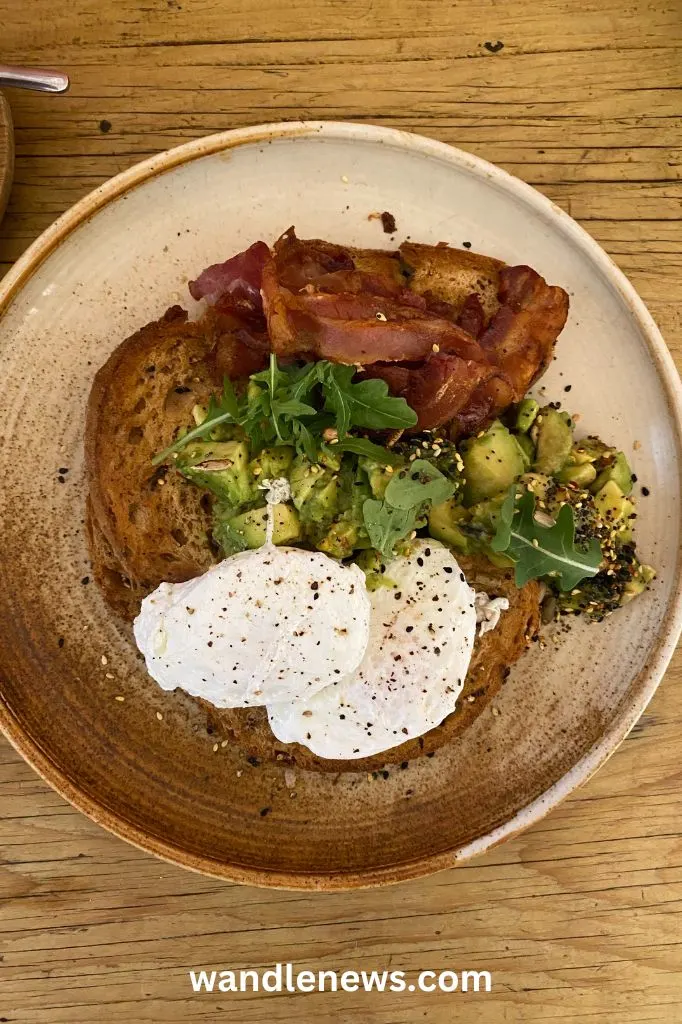 Smashed avo with eggs and streaky bacon at Belle Amie